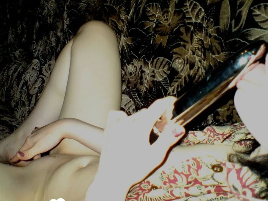 Smoking wife using a long metal dildo