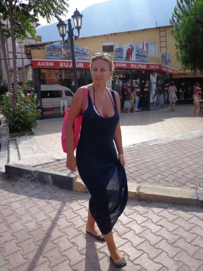 Blonde Milf Lifting Her Dress To Expose Shaved Pussy