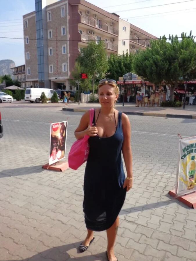 Blonde Milf Lifting Her Dress To Expose Shaved Pussy