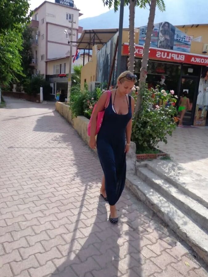Blonde Milf Lifting Her Dress To Expose Shaved Pussy