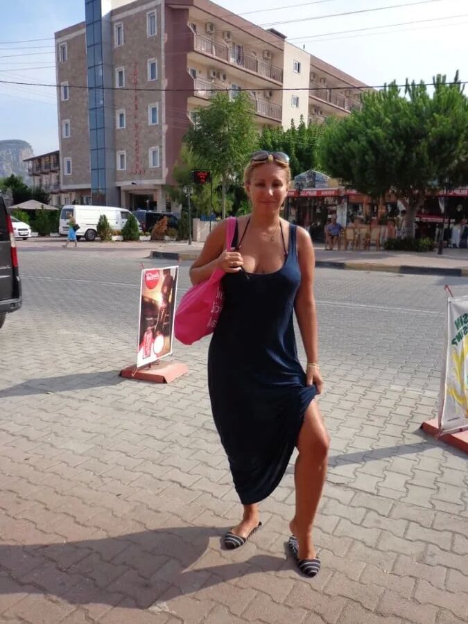 Blonde Milf Lifting Her Dress To Expose Shaved Pussy