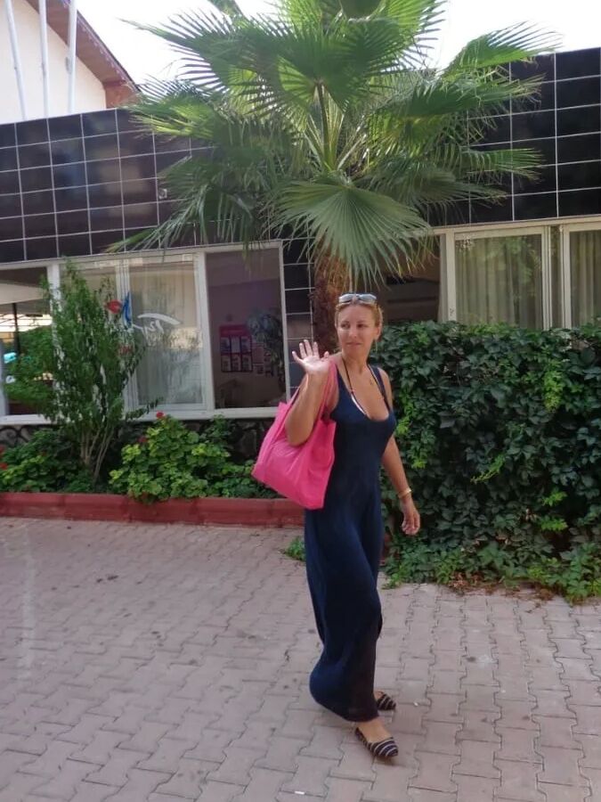 Blonde Milf Lifting Her Dress To Expose Shaved Pussy