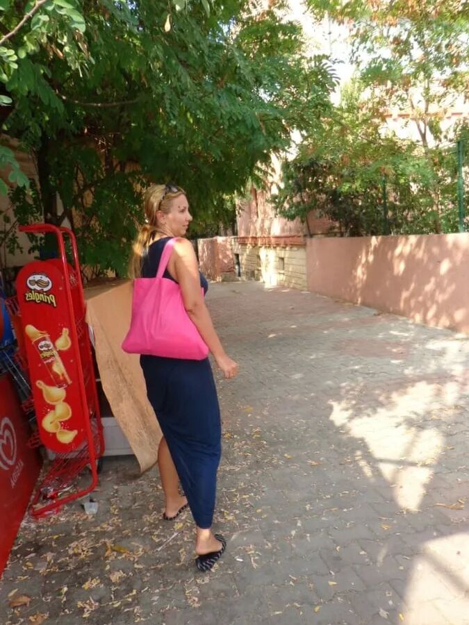 Blonde Milf Lifting Her Dress To Expose Shaved Pussy
