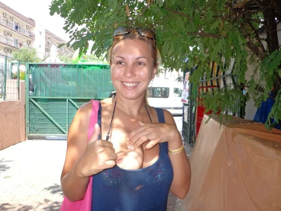 Blonde Milf Lifting Her Dress To Expose Shaved Pussy