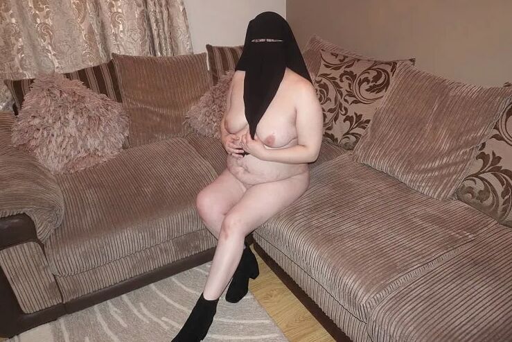 Posing naked in Niqab and ankle boots