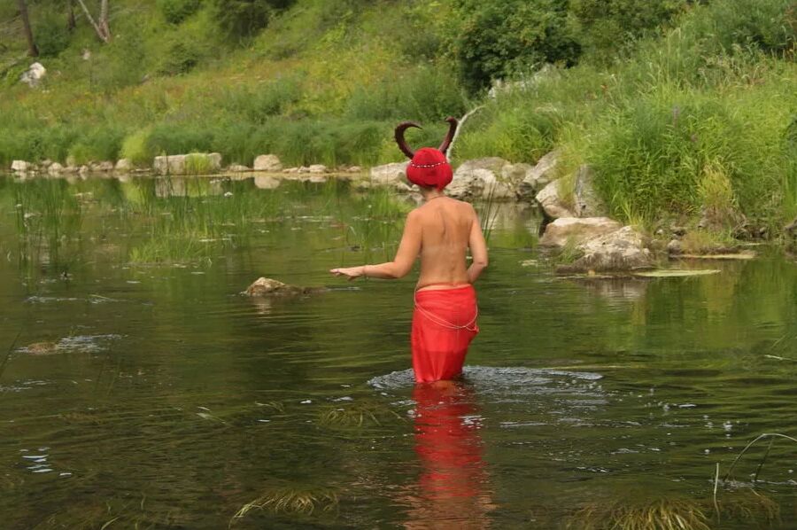 With Horns In Red Dress In Shallow River