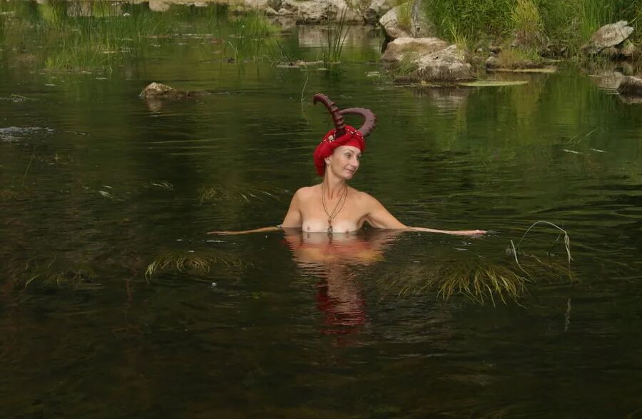 With Horns In Red Dress In Shallow River
