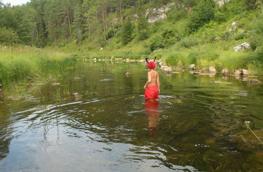With Horns In Red Dress In Shallow River