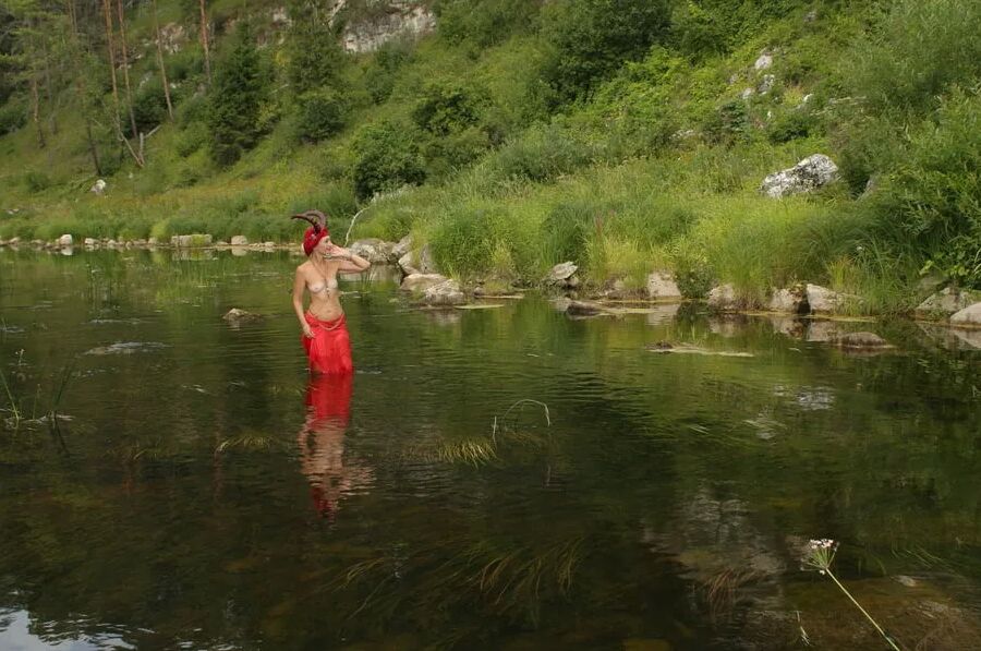 With Horns In Red Dress In Shallow River