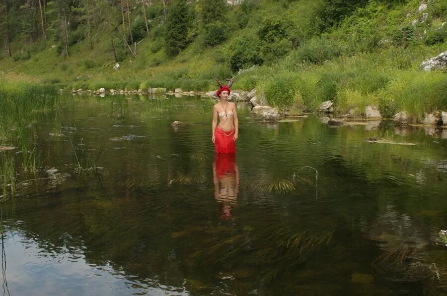 With Horns In Red Dress In Shallow River