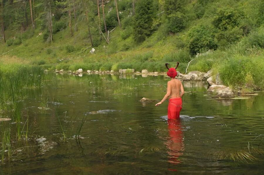 With Horns In Red Dress In Shallow River