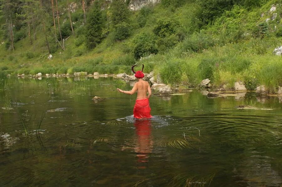 With Horns In Red Dress In Shallow River