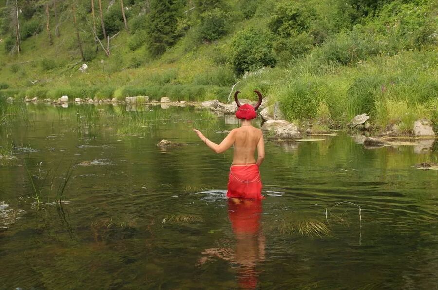 With Horns In Red Dress In Shallow River