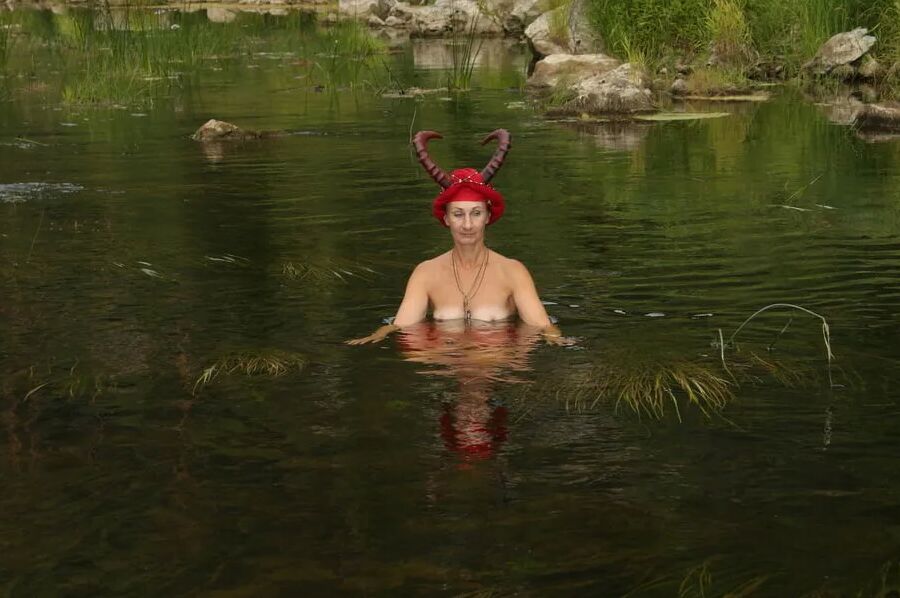With Horns In Red Dress In Shallow River
