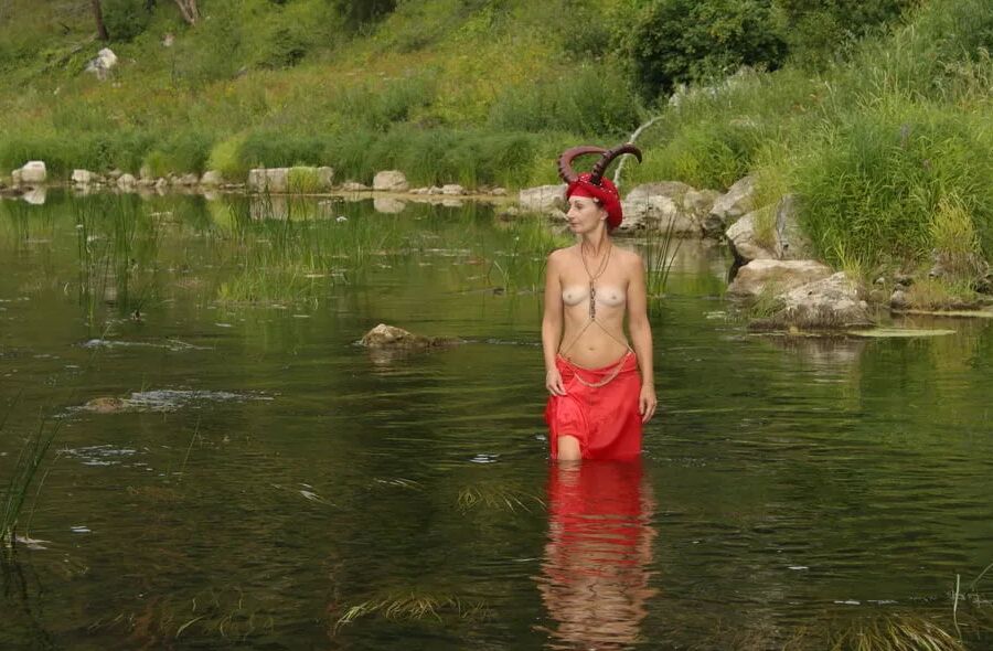 With Horns In Red Dress In Shallow River