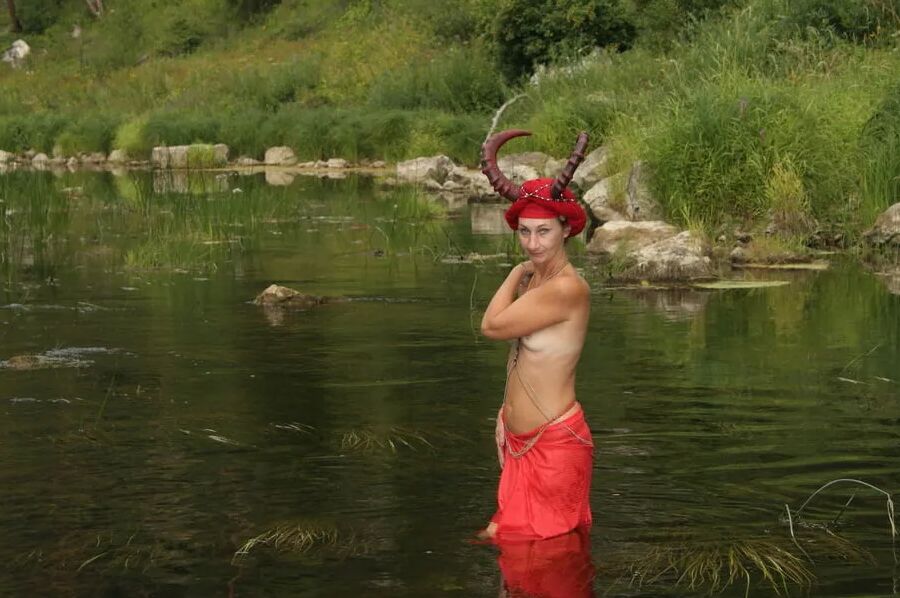 With Horns In Red Dress In Shallow River