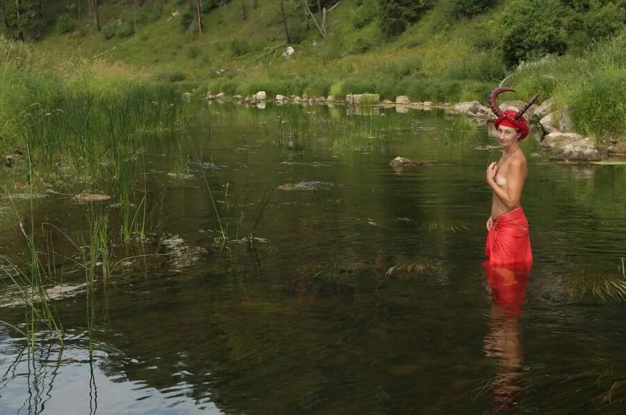With Horns In Red Dress In Shallow River