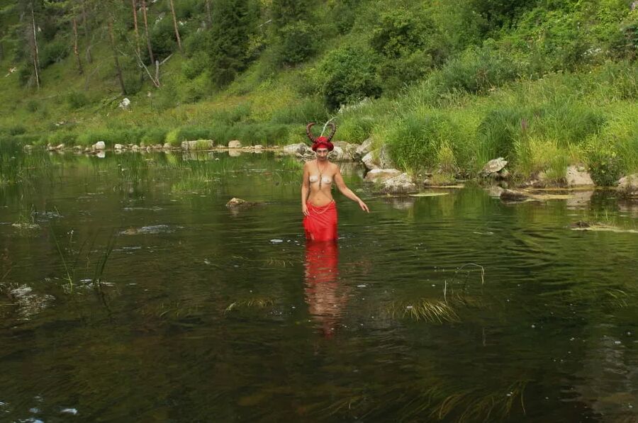 With Horns In Red Dress In Shallow River