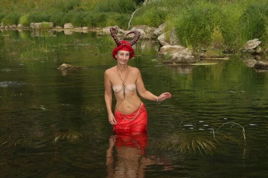 With Horns In Red Dress In Shallow River
