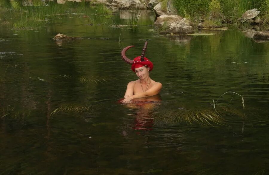 With Horns In Red Dress In Shallow River