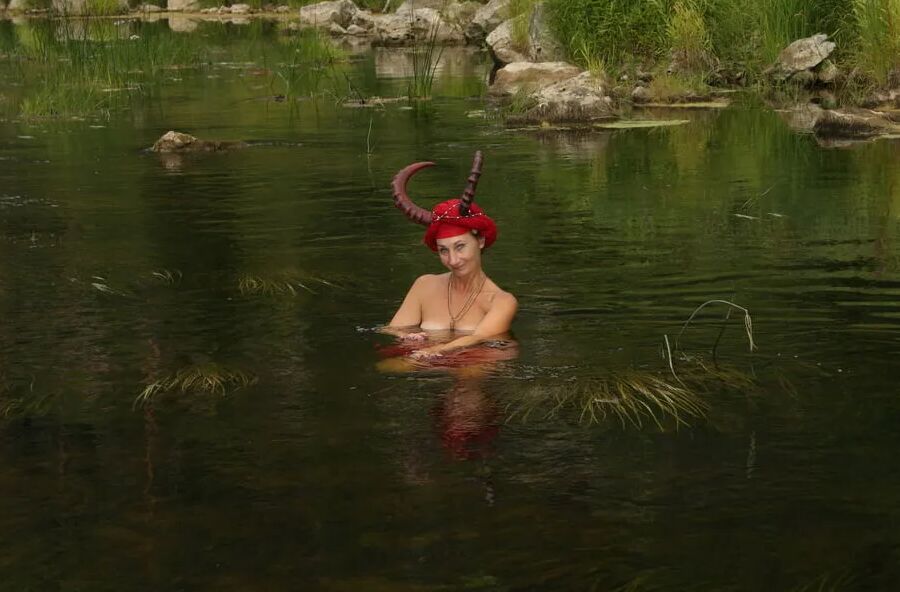 With Horns In Red Dress In Shallow River