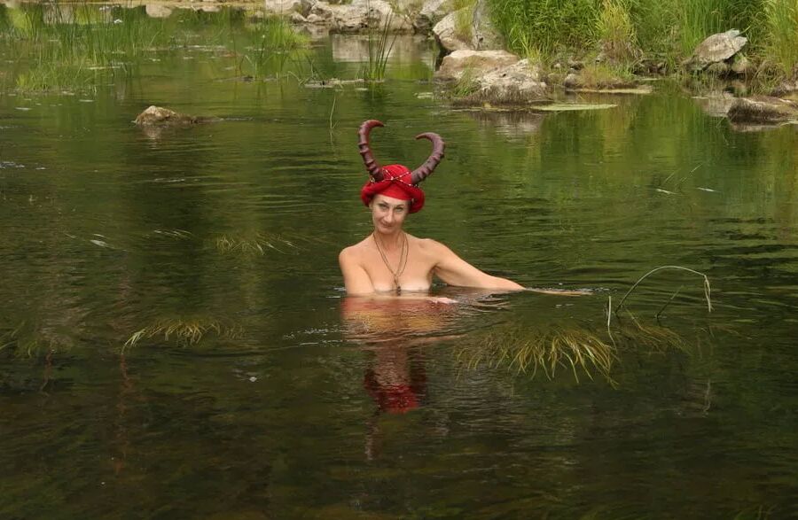 With Horns In Red Dress In Shallow River
