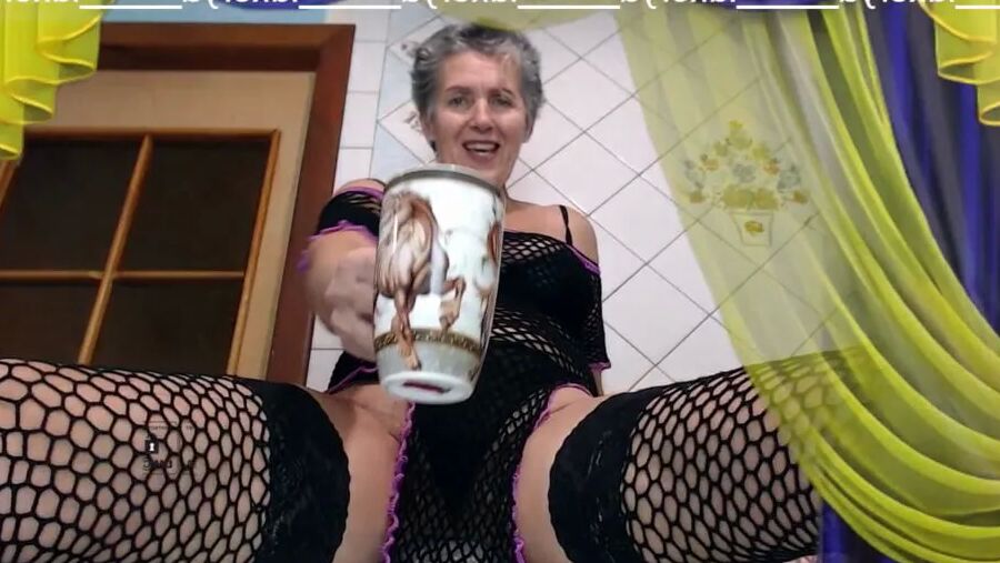 A hot housewife in the kitchen wears white transparent panty