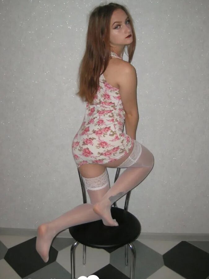 Brunette showing off her tattooed leg in stockings