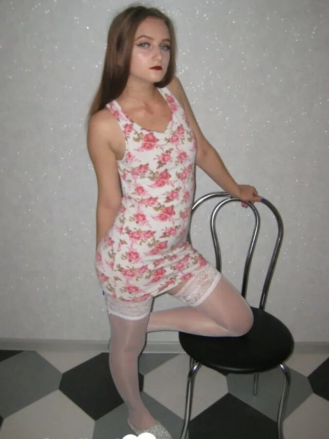 Brunette showing off her tattooed leg in stockings