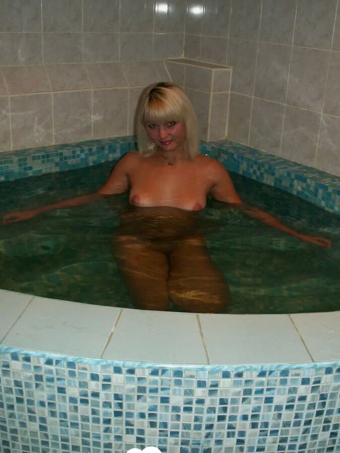 Blonde girlfriend teases in a warm tub
