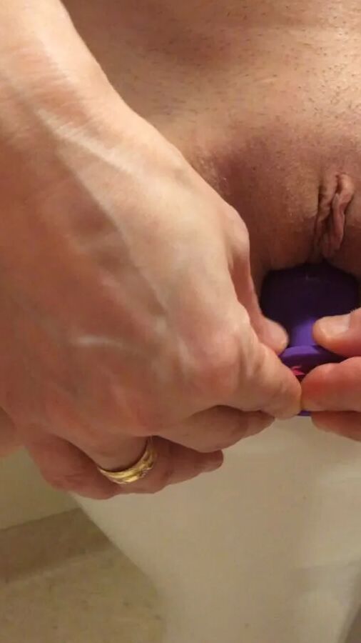 Playing with a dildo a little in bathroom