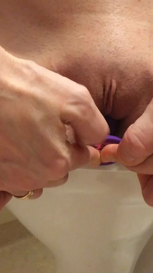 Playing with a dildo a little in bathroom