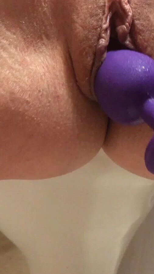 Playing with a dildo a little in bathroom