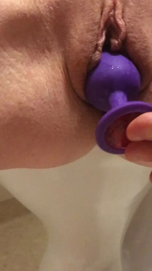 Playing with a dildo a little in bathroom