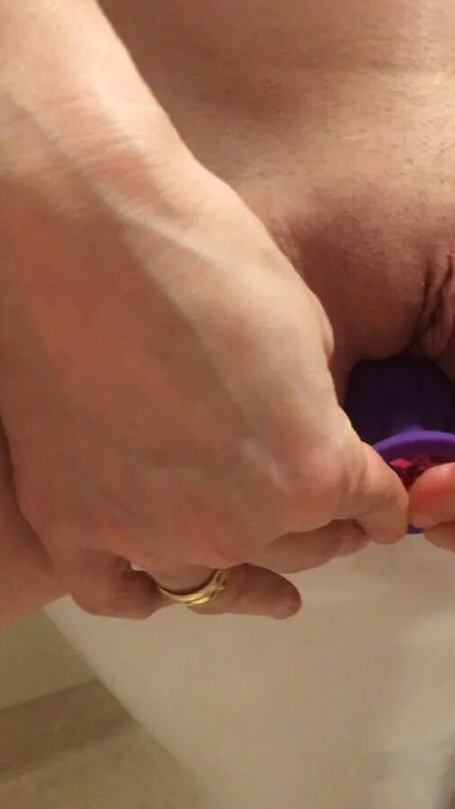 Playing with a dildo a little in bathroom