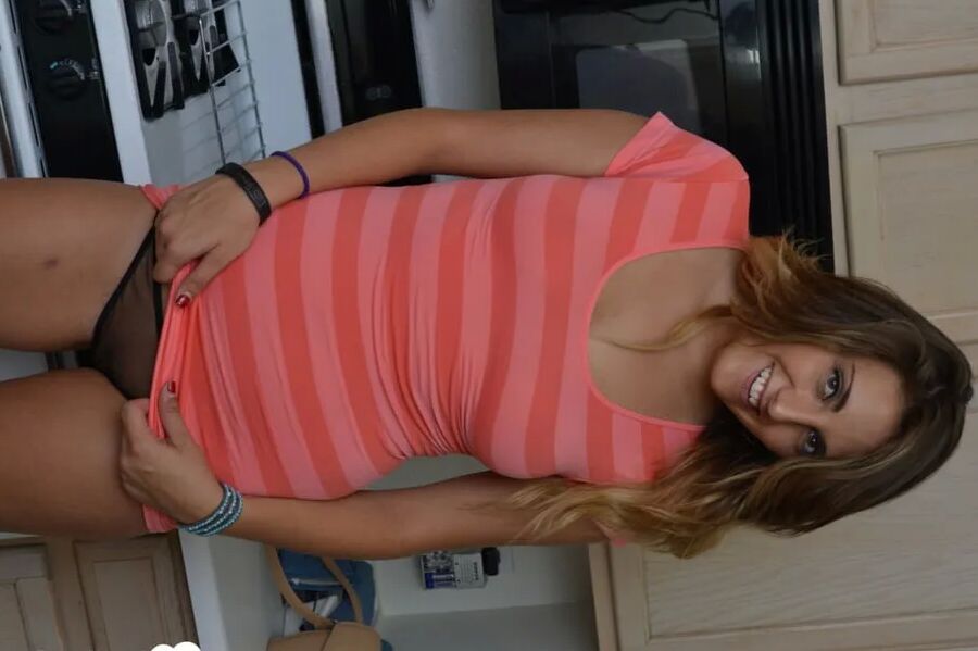 Attractive brunette lifts up her cute dress