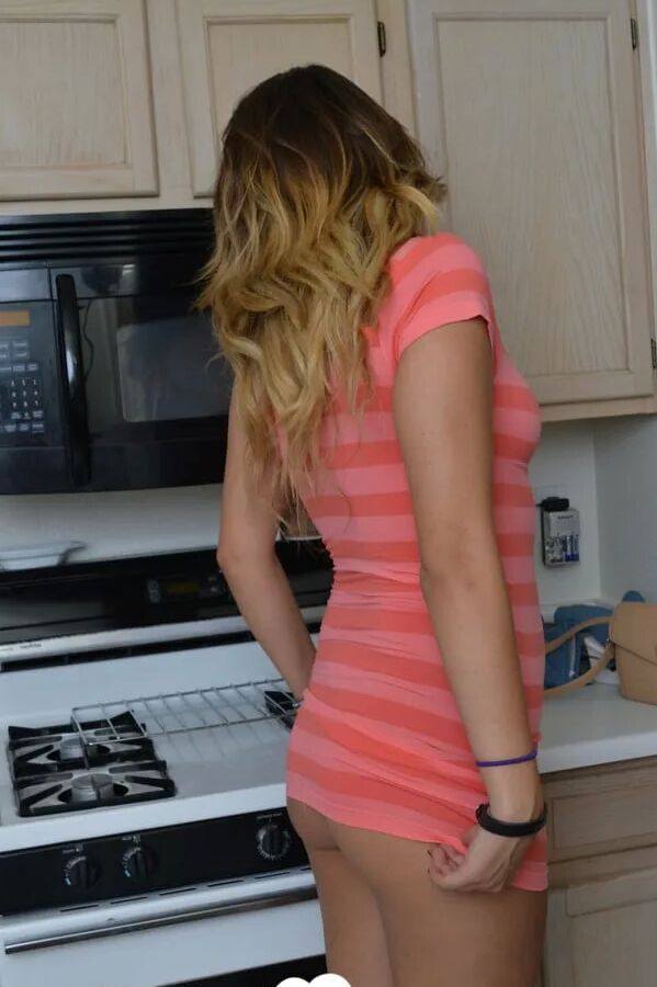 Attractive brunette lifts up her cute dress