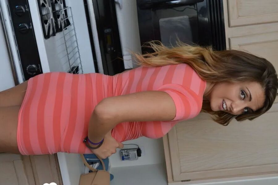 Attractive brunette lifts up her cute dress