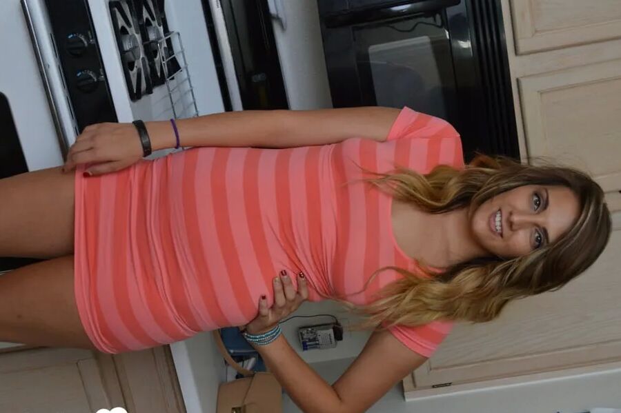 Attractive brunette lifts up her cute dress