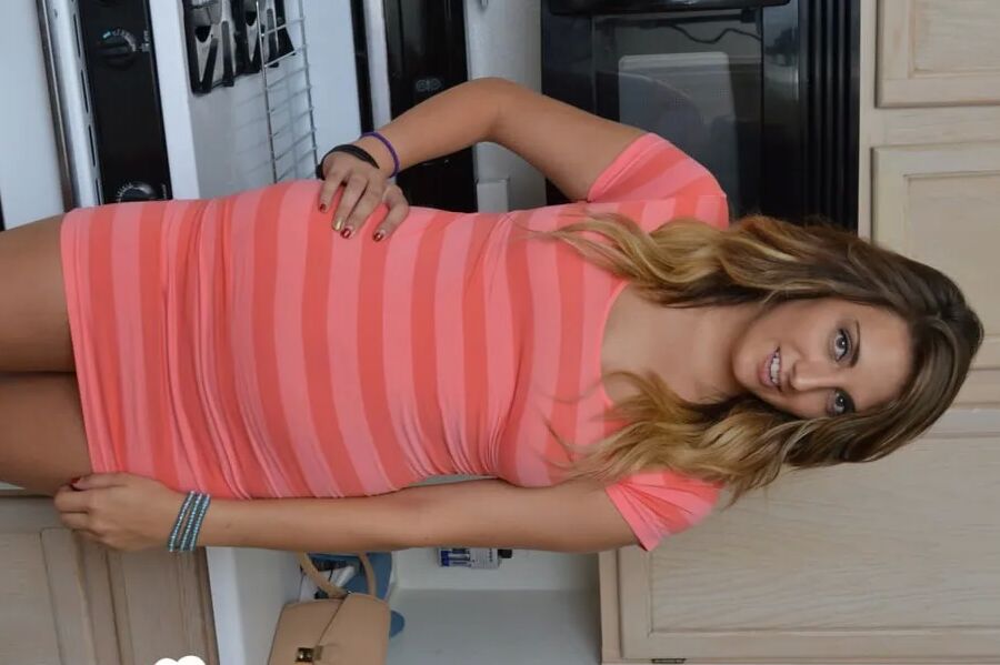 Attractive brunette lifts up her cute dress