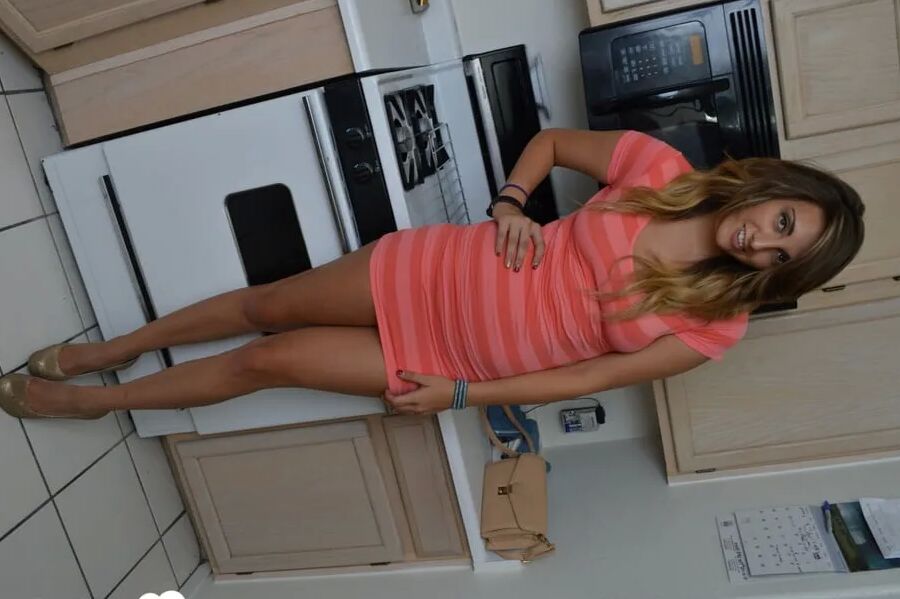 Attractive brunette lifts up her cute dress