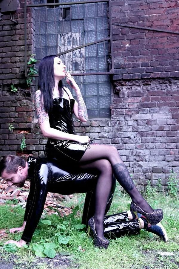 Dominatrix Nika on a walk with her slave.