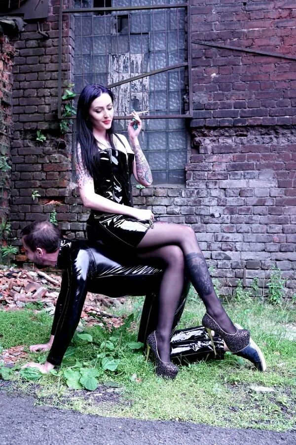 Dominatrix Nika on a walk with her slave.