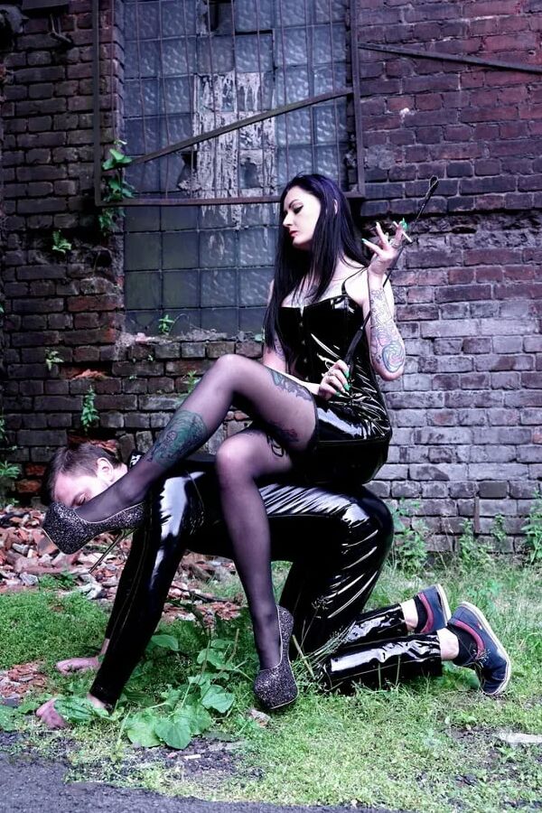 Dominatrix Nika on a walk with her slave.