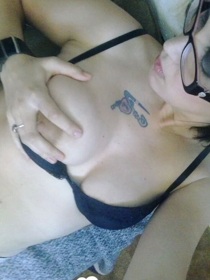 Cutie with glasses sucks on a blue dildo