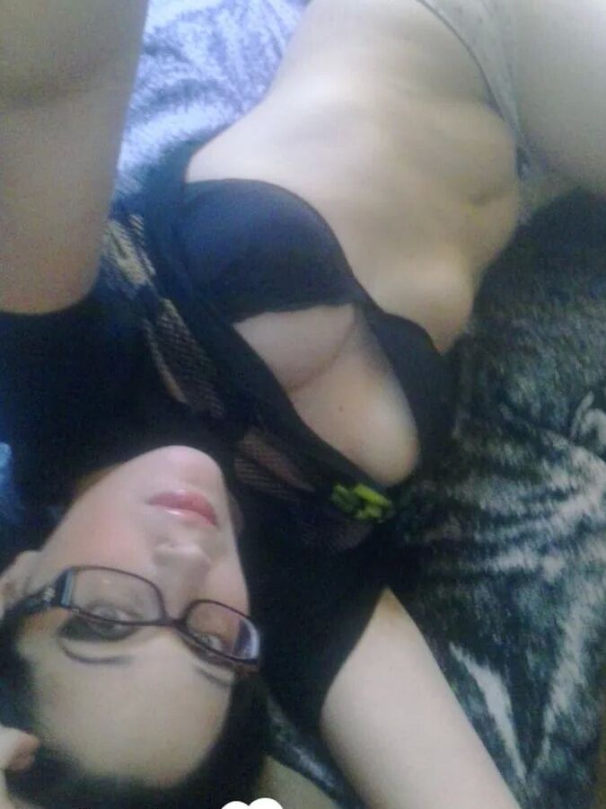 Cutie with glasses sucks on a blue dildo