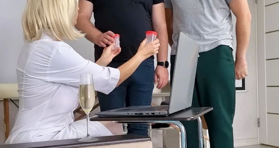 Sperm donation at the doctor's office. Nurse helps two men c