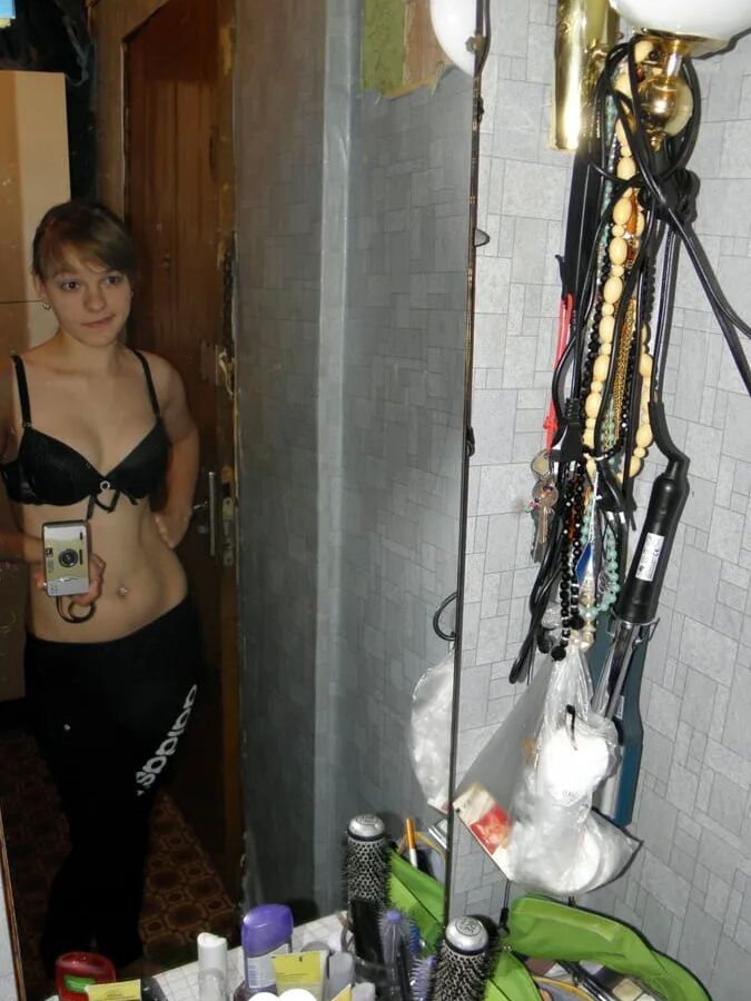 Petite teen slowly strips off her clothes