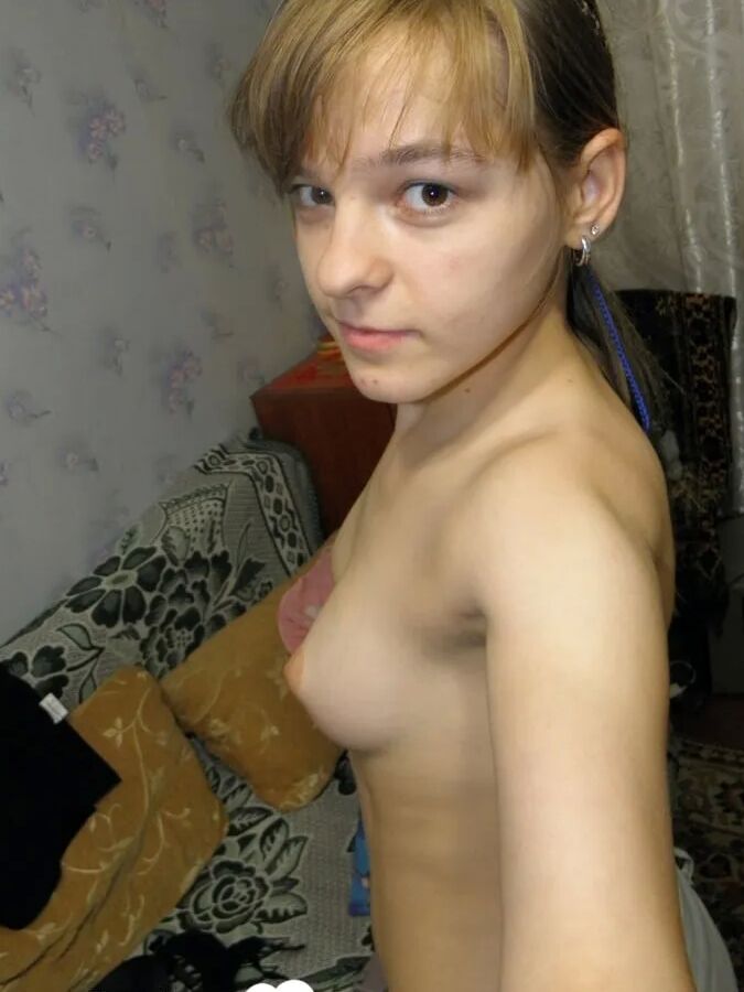 Petite teen slowly strips off her clothes