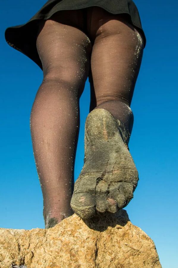 Torn and dirty feet in pantyhose outdoor